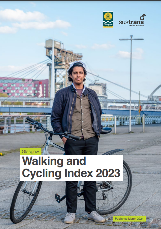 Man standing by a bicycle in Glasgow on cover of report